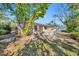 Backyard view showcasing the home's exterior, yard and a large tree offering shade at 90 Huron Ave, Tampa, FL 33606