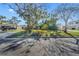 Street view of the home showing the front yard with mature trees and lush landscaping at 90 Huron Ave, Tampa, FL 33606