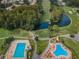 Aerial view of community with pools, golf course, and lush landscaping at 9204 Golf View Dr, New Port Richey, FL 34655