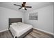 Serene bedroom with a queen bed, ceiling fan, and wood-look floors at 9204 Golf View Dr, New Port Richey, FL 34655