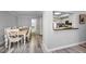 Dining area with a light wooden table and white chairs at 9204 Golf View Dr, New Port Richey, FL 34655