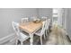 Dining area with a light wooden table and white chairs at 9204 Golf View Dr, New Port Richey, FL 34655