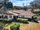 Single-story home with a tile roof, landscaped yard, and driveway at 9204 Golf View Dr, New Port Richey, FL 34655