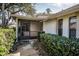 Front entry with screened porch and well-manicured hedges at 9204 Golf View Dr, New Port Richey, FL 34655