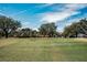 Golf course with players putting on the green at 9204 Golf View Dr, New Port Richey, FL 34655