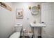 Modern bathroom with pedestal sink, gold fixtures, and hexagon tile floor at 9893 111Th St, Seminole, FL 33772