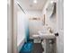 Bathroom with pedestal sink, white subway tile and blue accents at 9893 111Th St, Seminole, FL 33772