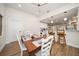 Bright dining area with farmhouse table and chairs, adjacent to kitchen at 9893 111Th St, Seminole, FL 33772