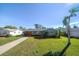 Well-maintained home exterior features a gray facade, updated garage door and landscaping at 9893 111Th St, Seminole, FL 33772