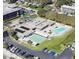 Aerial view of Bay Pines Condo Recreation Center featuring a pool, tennis courts, and parking lot at 9940 47Th N Ave # 102-C, St Petersburg, FL 33708