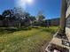 Grassy backyard and landscaping with mature trees at 9940 47Th N Ave # 102-C, St Petersburg, FL 33708