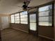 Well-lit Florida room with large windows and vinyl floors at 9940 47Th N Ave # 102-C, St Petersburg, FL 33708