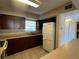 Kitchen featuring wood cabinets, laminate countertops, tile flooring, and a white refrigerator at 9940 47Th N Ave # 102-C, St Petersburg, FL 33708