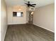 Living room featuring hardwood floors, a ceiling fan, and a serving hatch to the kitchen at 9940 47Th N Ave # 102-C, St Petersburg, FL 33708