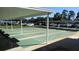 Outdoor shuffleboard courts in a parking lot with covered benches and numerous parked cars in the background at 9940 47Th N Ave # 102-C, St Petersburg, FL 33708