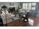 Living room with hardwood floors, white couches, and a black recliner at 1819 Shore S Dr # 210, South Pasadena, FL 33707