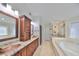 Elegant bathroom with double vanity, soaking tub, and walk-in shower at 1011 Sonata Ln, Apollo Beach, FL 33572