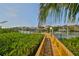 Wooden walkway to private dock with boat slips at 1011 Sonata Ln, Apollo Beach, FL 33572