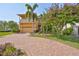 Beautiful two-story home with a brick driveway and lush landscaping at 1011 Sonata Ln, Apollo Beach, FL 33572