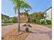 Two-story home with a yellow exterior and palm trees at 1011 Sonata Ln, Apollo Beach, FL 33572