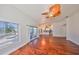 Spacious living room featuring hardwood floors and sliding doors leading to the pool area at 1011 Sonata Ln, Apollo Beach, FL 33572