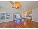 Bright living room with hardwood floors, a view of the pool, and access to the kitchen at 1011 Sonata Ln, Apollo Beach, FL 33572