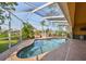 Relaxing kidney-shaped pool with a screened enclosure at 1011 Sonata Ln, Apollo Beach, FL 33572