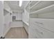 Bright walk-in closet with ample shelving and drawers at 1011 Sonata Ln, Apollo Beach, FL 33572