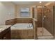 Bathroom with soaking tub and walk-in shower at 11601 Mansfield Point Dr, Riverview, FL 33569