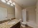 Clean bathroom with granite countertop, tub, and shower at 11601 Mansfield Point Dr, Riverview, FL 33569