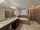 Bathroom with double vanity, soaking tub, and shower at 11601 Mansfield Point Dr, Riverview, FL 33569