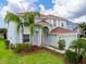 Two-story house with light gray siding, red door, and a landscaped yard at 11601 Mansfield Point Dr, Riverview, FL 33569