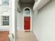 Red front door with arched window and tile flooring at 11601 Mansfield Point Dr, Riverview, FL 33569