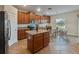 Kitchen with wood cabinets, granite countertops, and an island at 11601 Mansfield Point Dr, Riverview, FL 33569