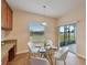 Kitchen nook with glass table and chairs, overlooking the backyard at 11601 Mansfield Point Dr, Riverview, FL 33569