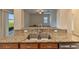 Kitchen island with granite countertop and double sink at 11601 Mansfield Point Dr, Riverview, FL 33569