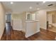 Upstairs hallway with bathroom access and hardwood floors at 11601 Mansfield Point Dr, Riverview, FL 33569