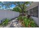 Backyard featuring lush greenery, stepping stones, and a privacy fence at 1201 77Th N St, St Petersburg, FL 33710