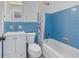 Cozy bathroom showcasing blue tiling, a white sink vanity, and a shower-tub combo at 1201 77Th N St, St Petersburg, FL 33710