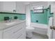 Clean bathroom featuring modern vanity, tub with shower, and bright green accents at 1201 77Th N St, St Petersburg, FL 33710