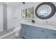 Stylish bathroom featuring a dual sink vanity, decorative tile, and a walk-in shower at 1201 77Th N St, St Petersburg, FL 33710