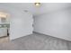 Spacious bedroom connected to a bathroom with gray carpet, light walls, and ample natural light at 1201 77Th N St, St Petersburg, FL 33710