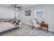 Spacious bedroom with ample natural light, ceiling fan, and a comfortable sitting area at 1201 77Th N St, St Petersburg, FL 33710