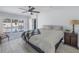 Bright bedroom featuring a ceiling fan, accent wall, and sliding glass doors to pool at 1201 77Th N St, St Petersburg, FL 33710