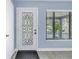 Foyer with decorative door with sidelight and wood-look floors at 1201 77Th N St, St Petersburg, FL 33710