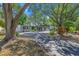 Charming single-story home with mature trees and beautifully landscaped front yard at 1201 77Th N St, St Petersburg, FL 33710