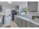 Well-lit kitchen featuring gray cabinets, marble countertops, and stainless steel appliances at 1201 77Th N St, St Petersburg, FL 33710