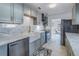 Updated kitchen with marble countertops, gray cabinets, a farmhouse sink, and stainless steel appliances at 1201 77Th N St, St Petersburg, FL 33710