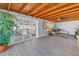 Bright living room with exposed wood ceiling, light-colored walls and a large plant at 1201 77Th N St, St Petersburg, FL 33710