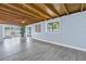 Living room featuring exposed wood ceiling, light-colored walls, and sliding doors at 1201 77Th N St, St Petersburg, FL 33710